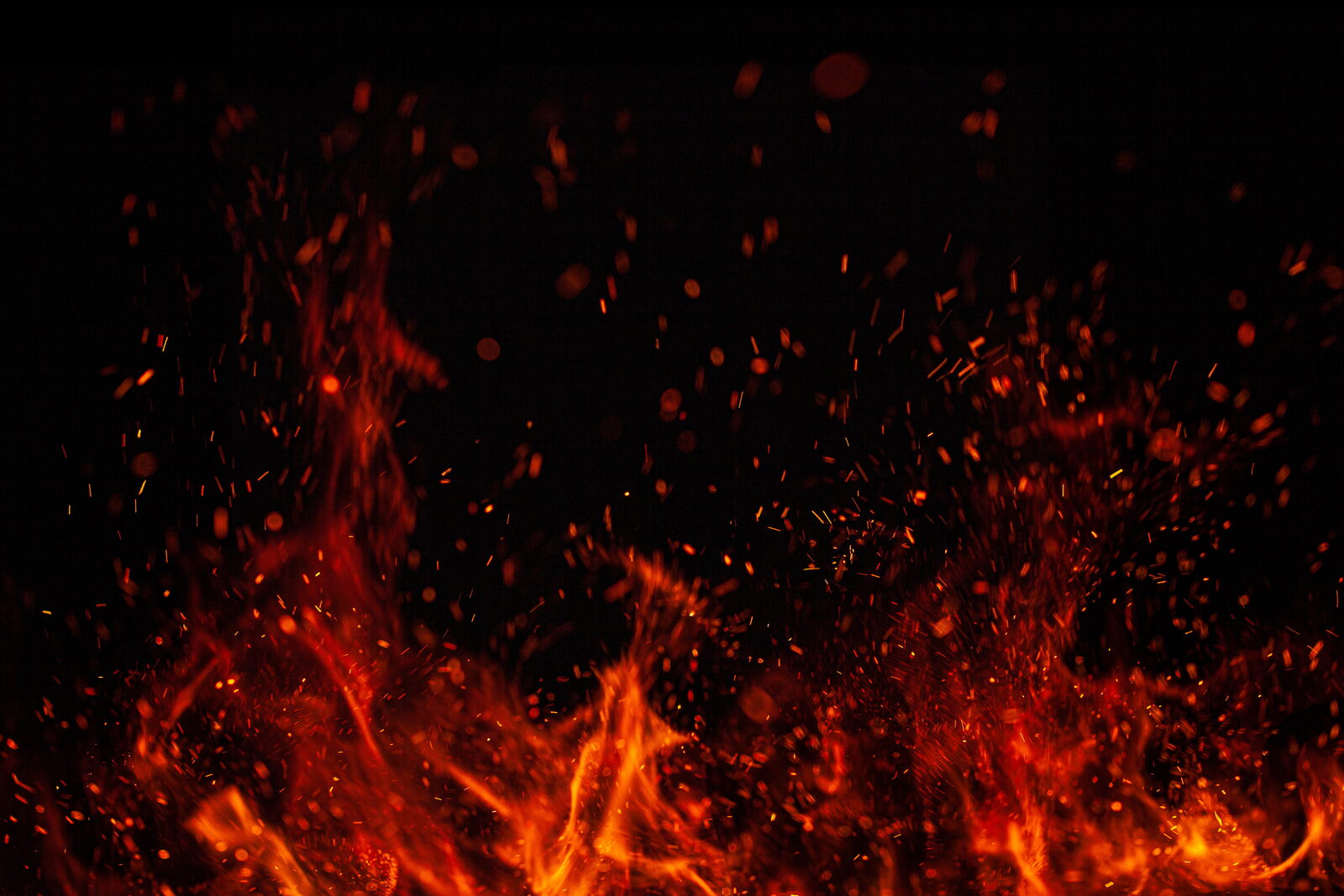 Flames and embers against a dark background