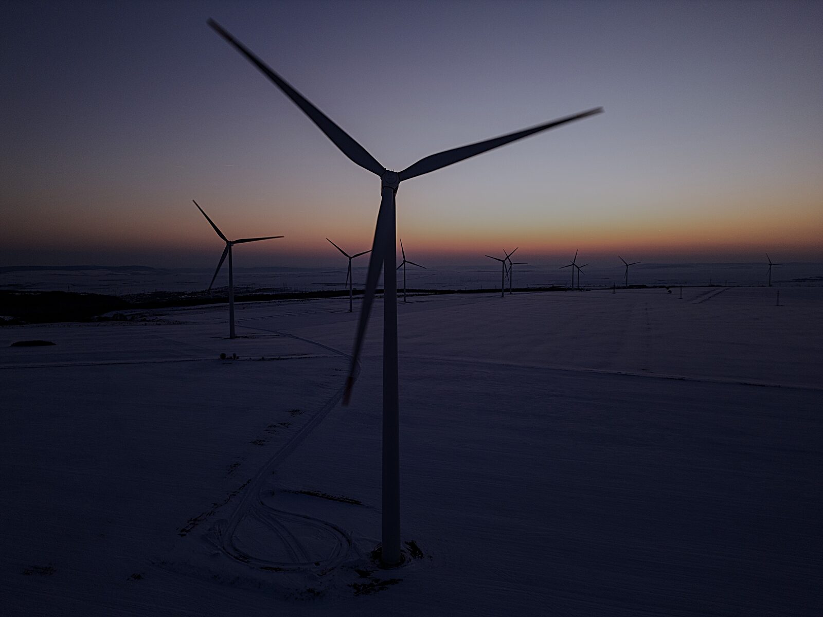 Wind turbine in winter conditions at dusk